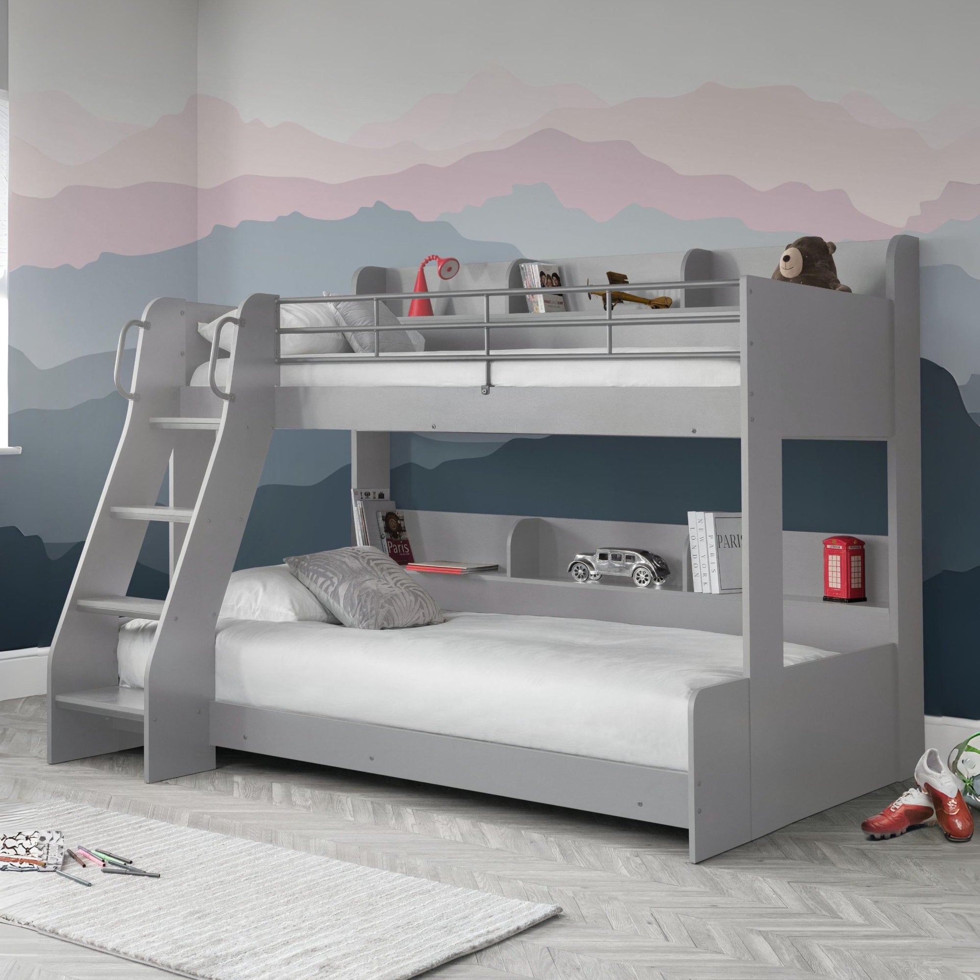 Gray bunk bed in a room with a mountain mural on the wall.